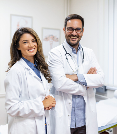Portrait of smiling young doctors standing together. Portrait Of Medical Staff Inside Modern Hospital Smiling To Camera